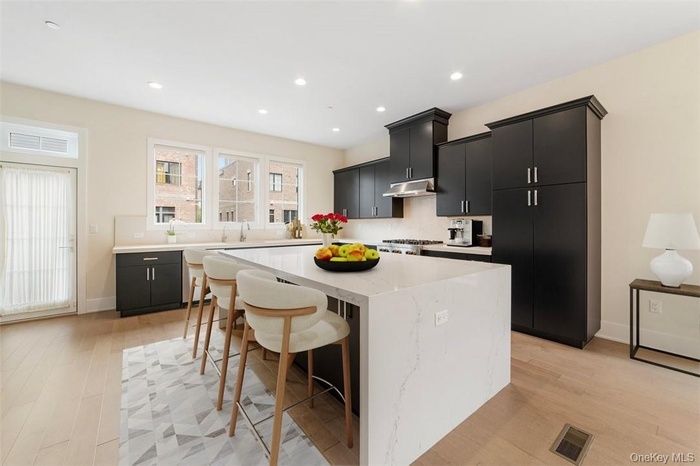 Magnificent kitchen with JennAir appliances, huge island w waterfall, lots of cabinetry, door to Balcony. Virtually staged