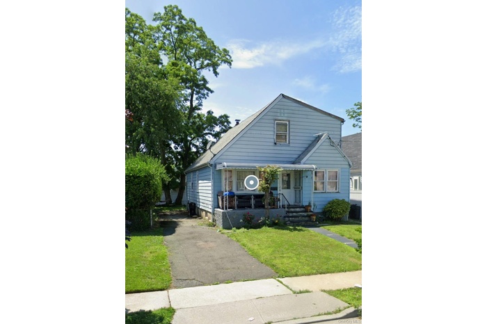 Front view of property, lawn and asphalt driveway