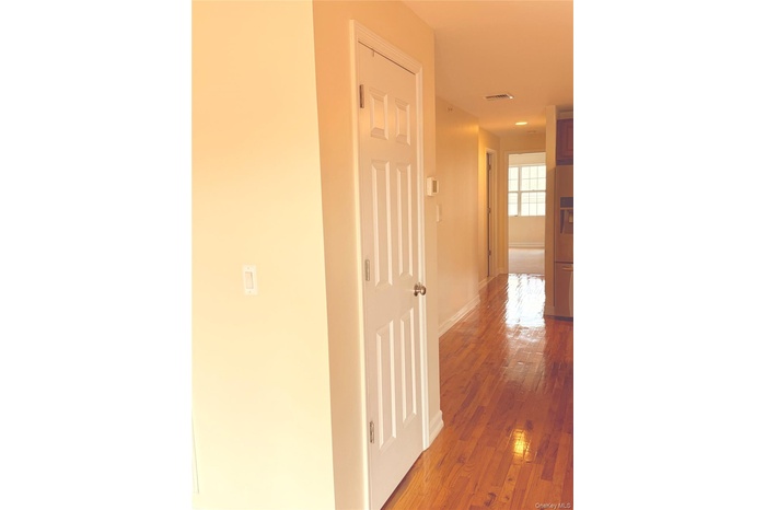 Hall featuring baseboards and light wood finished floors