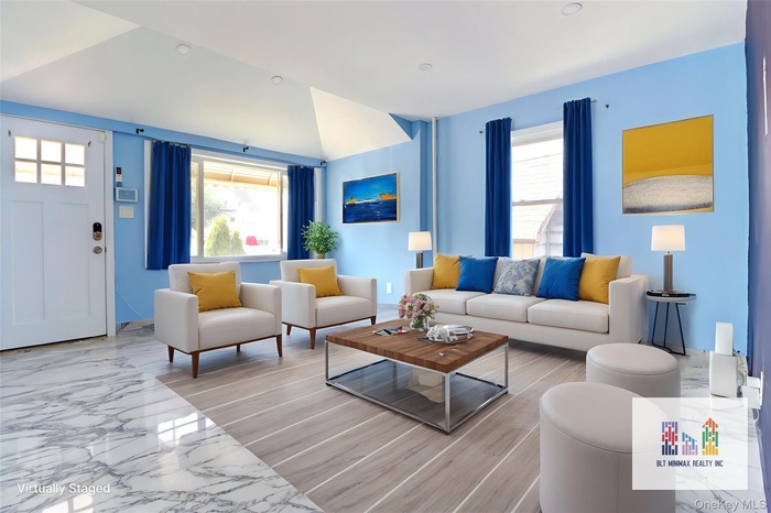 Living room with marble tiled flooring and lofted ceiling