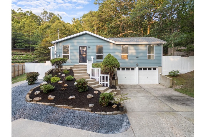 View of front of house with driveway and an attached garage