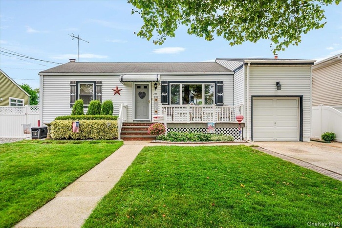 Ranch-style home featuring driveway and an attached garage