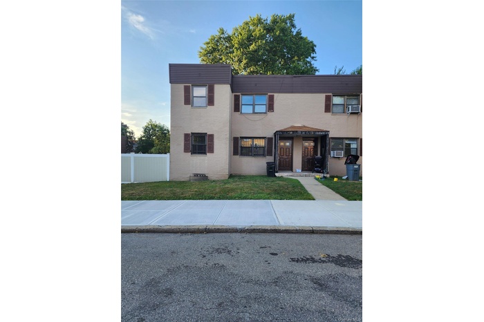 View of front of home featuring a front yard and brick siding