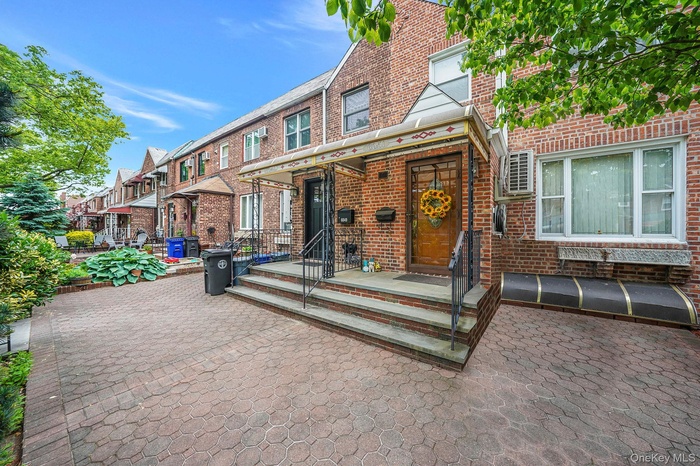 View of front of property with brick siding and a residential view
