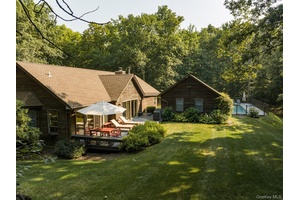 Nestled at the end of a long, private drive, this single level retreat set on 5 wooded acres offers exceptional privacy surrounded by a beautiful natural setting.