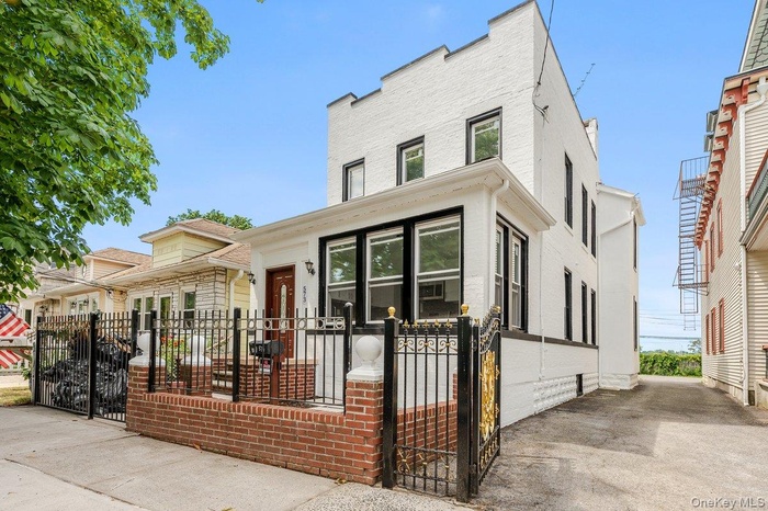 View of front of property featuring a gate and a fenced front yard