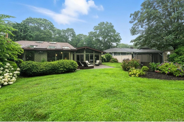View of green lawn featuring a gazebo, and a patio area