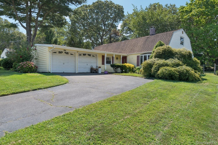 View of front of house and a two car garage and driveway