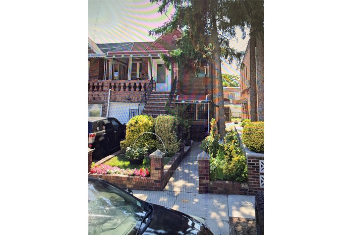 View of front of house featuring stairway and brick siding