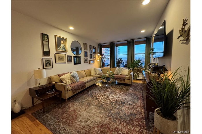 Living area with wood finished floors and recessed lighting