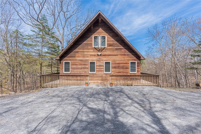 View of side of home featuring a wooden deck