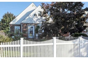 Spacious Cape Cod style Brick home on a quiet, tree lined street on a dead end block.