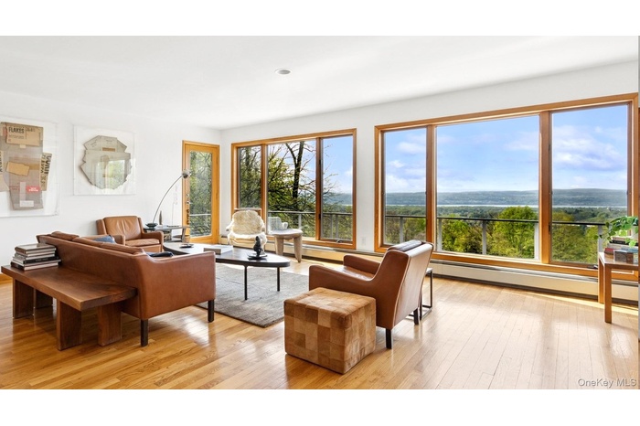 Living area with light wood-style floors and baseboard heating