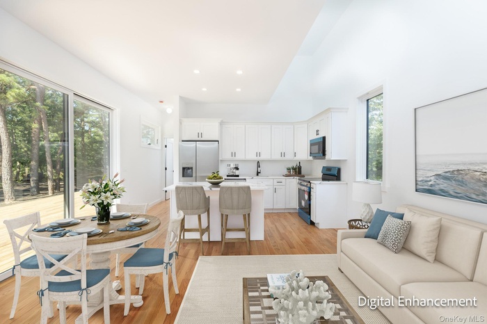 Living room featuring light wood-style flooring and recessed lighting