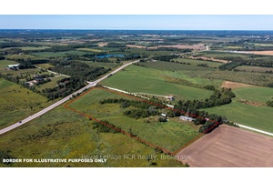 Brick bungalow with attached garage, 30x50 shop and a small barn on 16 acres.