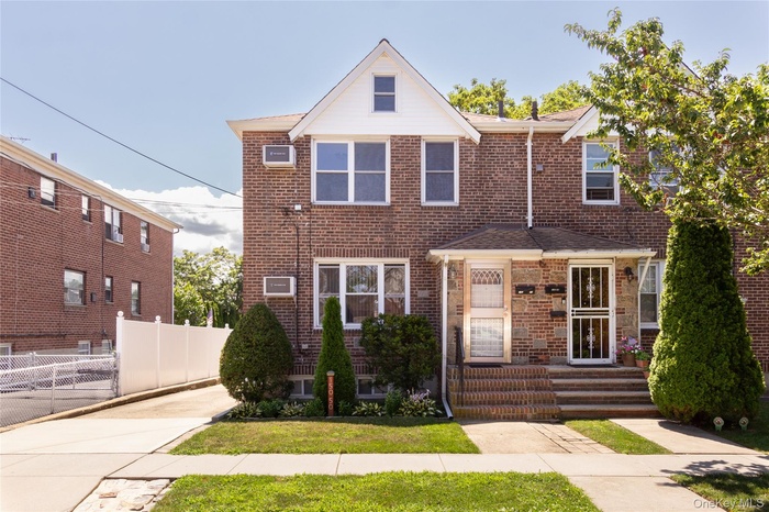 Traditional-style house with brick siding