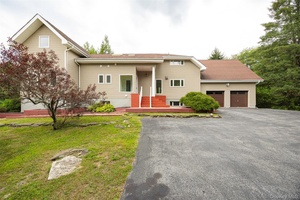 Custom 4 bedroom, 2 full bath, 2 half bath contemporary privately set on 5 acre parcel.