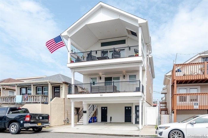 View of front of house with a carport and stairway