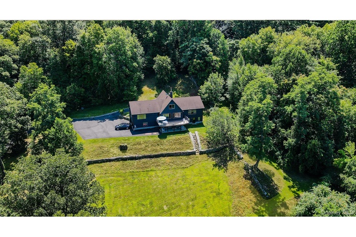 View from above of property with a forest