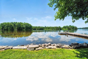 Waterfront oasis with western exposure on the beautiful Trent River with 70' of water frontage with dock and walk in shoreline.