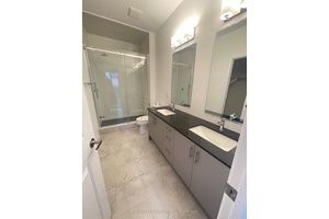 This brand new, rare find TH has a double car garage with drive way covered under porch.