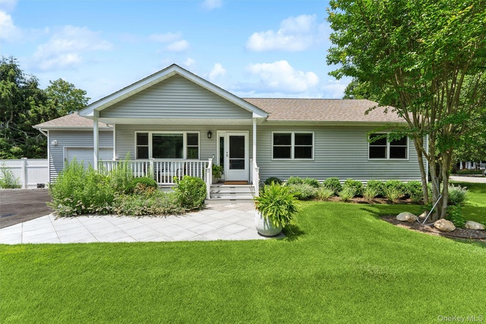 Ranch-style house with covered porch, a shingled roof, a garage, and driveway