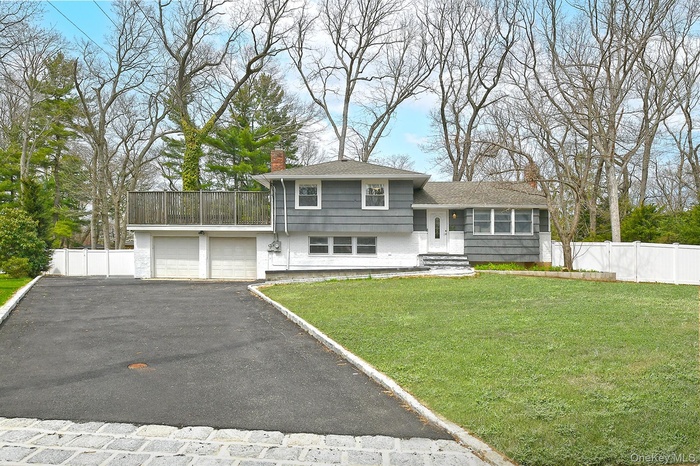 Expanded split level home featuring a 2+ car garage on a .5 acre lot on a quiet cul de sac
