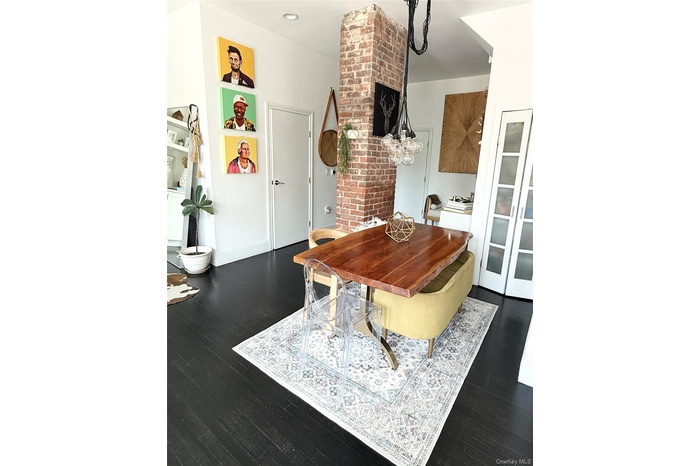 Dining room with dark wood-style flooring