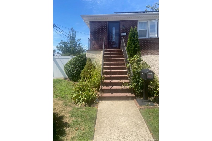 Property entrance featuring brick siding