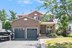 This sophisticated home is sure to impress, and its spacious foyer with circular hardwood staircase is a great start !