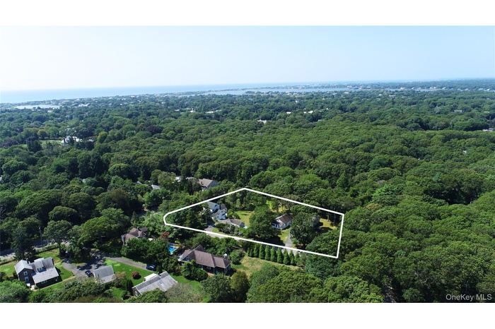 View of property location featuring property parcel outlined and a heavily wooded area
