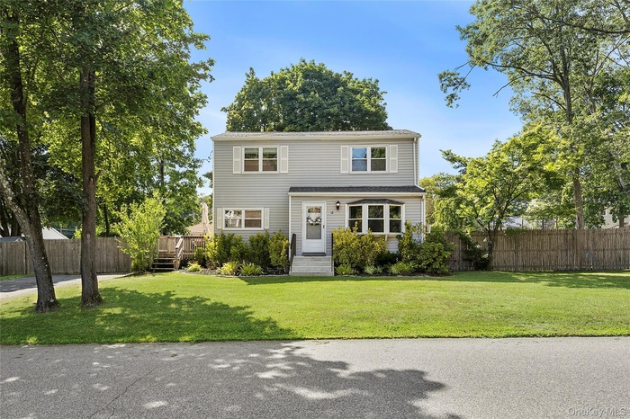 Traditional-style home featuring a wooden deck