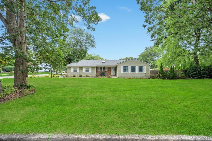 Ranch-style home featuring a front yard