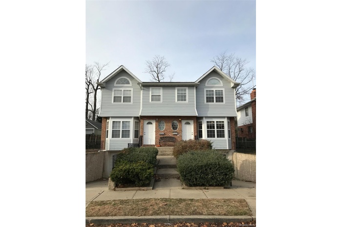 Colonial-style house featuring brick siding