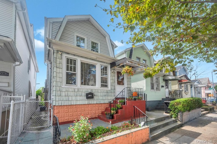 Dutch colonial with a gate and a gambrel roof