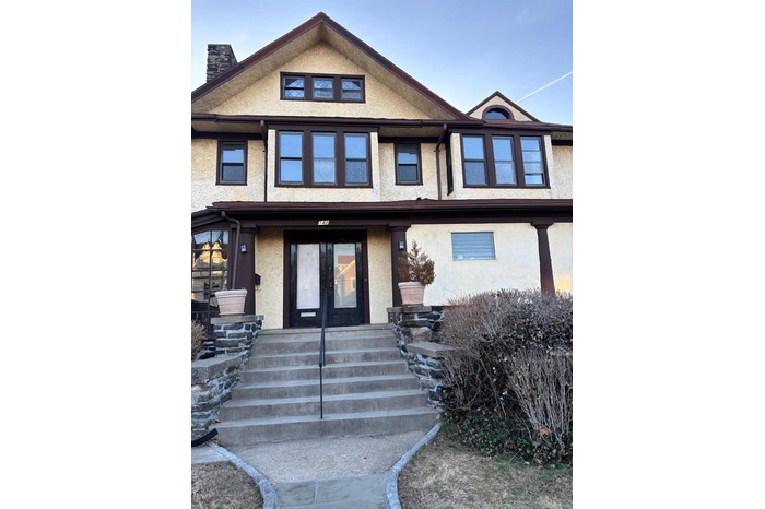 Multi unit property featuring stucco siding, french doors, and a chimney