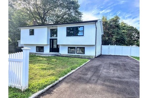 This beautifully updated high ranch offers modern living with attention to detail and style.