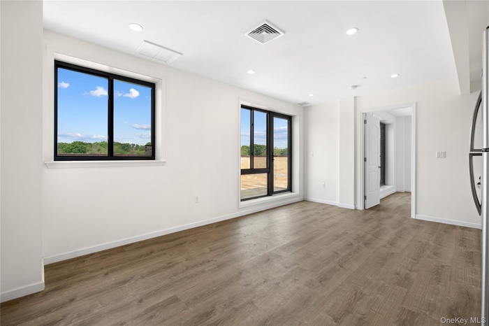 Unfurnished room with recessed lighting and wood finished floors