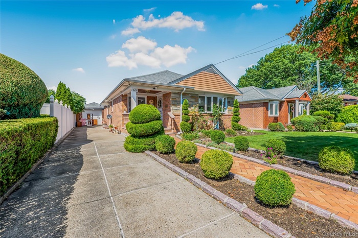 Bungalow-style house with brick siding and a shingled roof