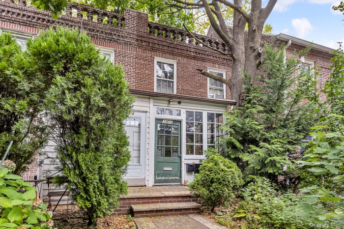 View of exterior entry with brick siding