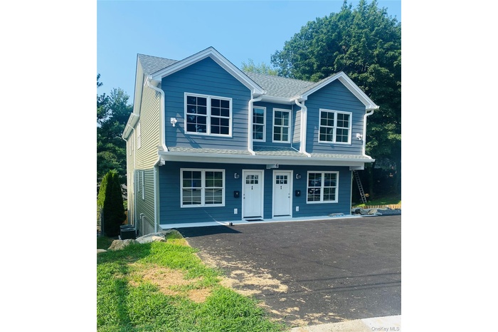 View of front of home with a porch and roof with shingles