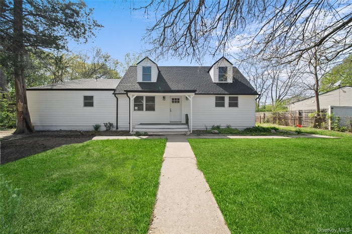 Cape cod-style house featuring a porch and roof with shingles