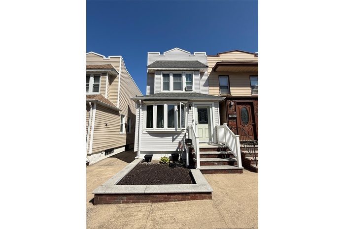 View of front of home featuring roof with shingles