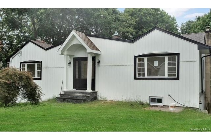 Ranch-style home with a front yard