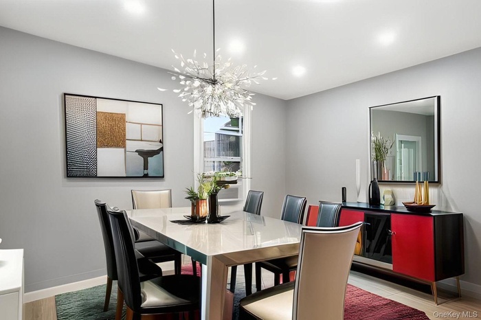 Dining room featuring wood finished floors and a chandelier