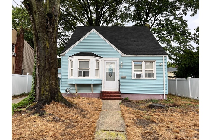 View of front facade featuring entry steps and roof with shingles