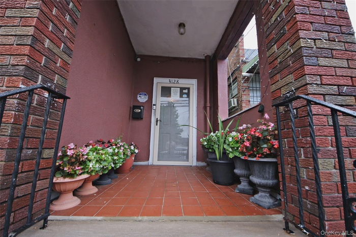 Entrance to property with stucco siding and stone siding