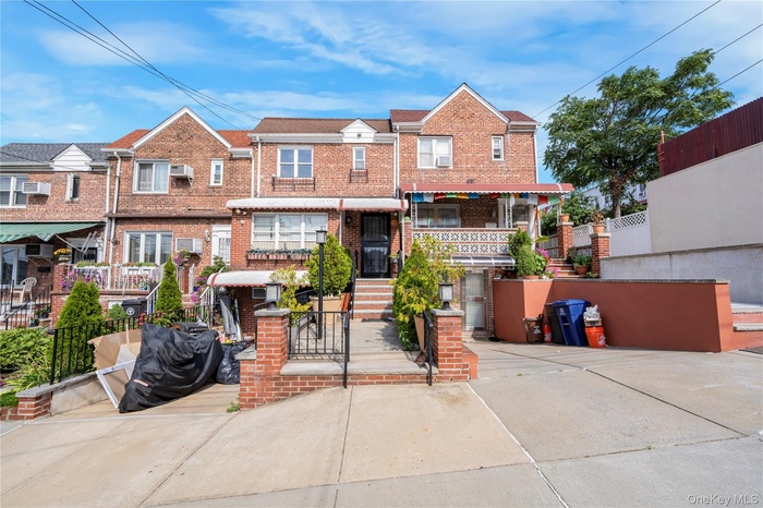 Traditional home featuring brick siding, a fenced front yard, driveway, a gate, and a residential view