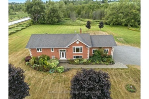 Beautiful 2 2 bedroom raised bungalow on 2 acres with park like setting backing onto a creek.