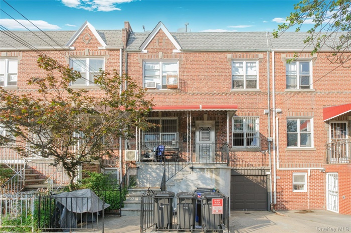 View of front of house featuring brick siding, an attached garage, concrete driveway, and a shingled roof